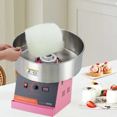 machine barbe a papa sur table avec desserts