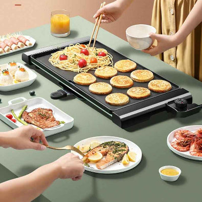 gens autour plancha electrique garnie aliments sur table